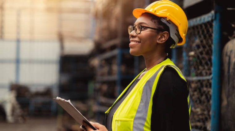 Happy Black African women engineer worker enjoy working in factory industry.