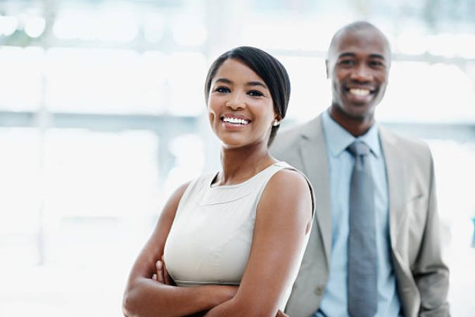 Two attractive African American businesspeople smiling - portrait