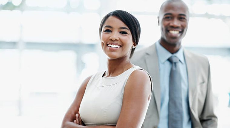 Two attractive African American businesspeople smiling - portrait