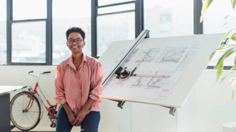 A portrait of a confident young architect in a modern office.